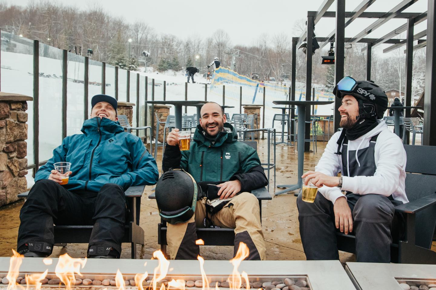 three friends around a fire