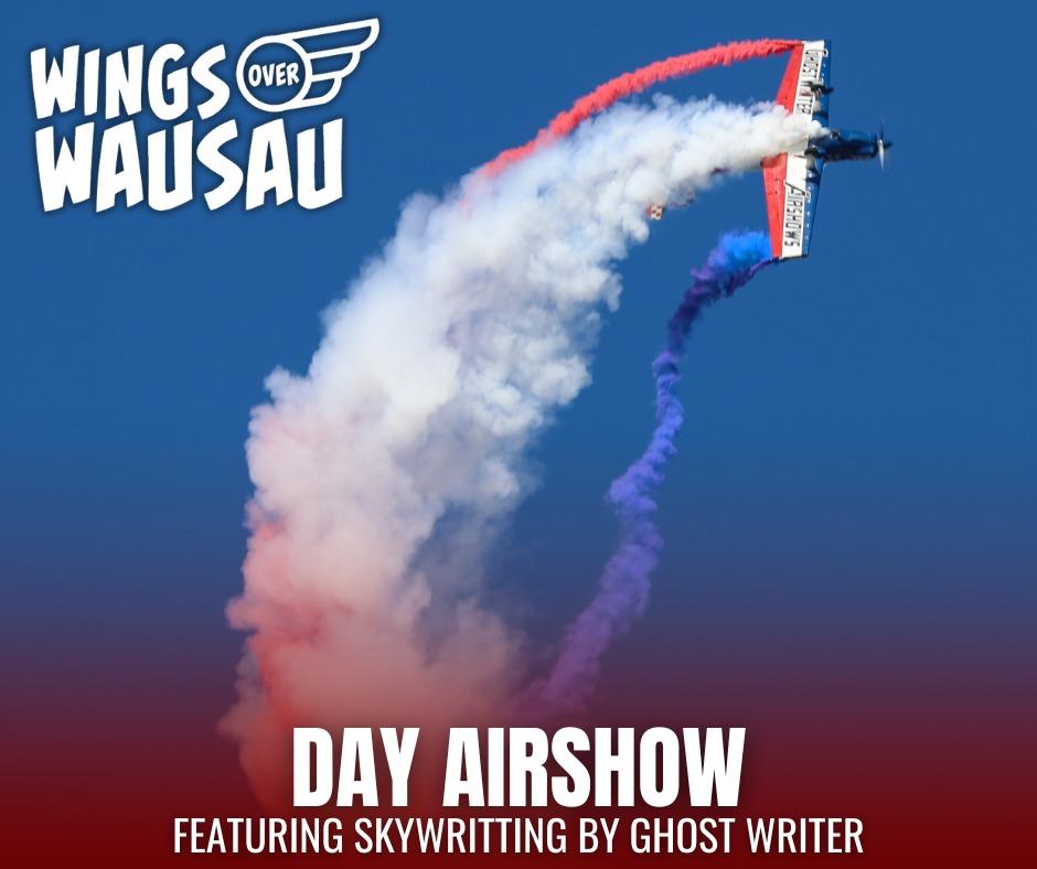 Airplane performing in a blue sky with colorful smoke trails.