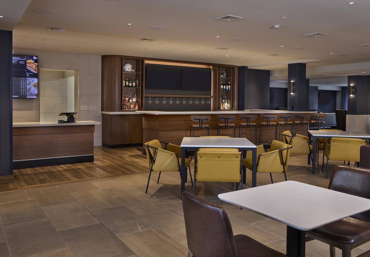 Modern restaurant interior with wooden furniture and neutral tones.