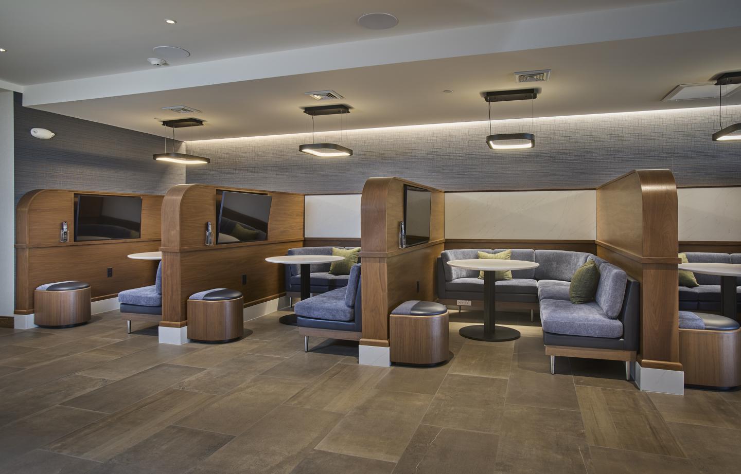 Modern lounge with wooden booths and soft seating.