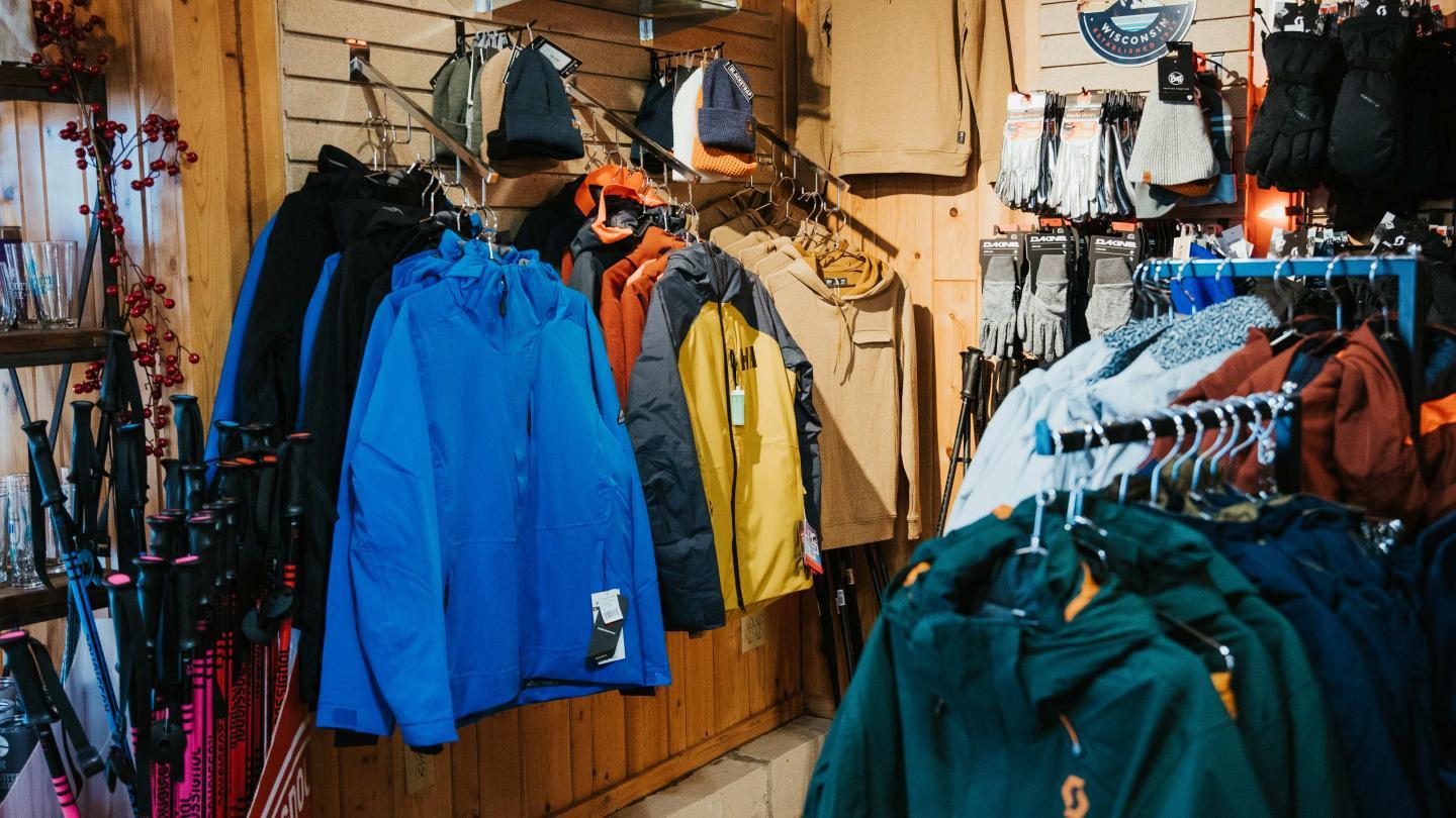 Outdoor clothing store with colorful jackets and accessories on display.
