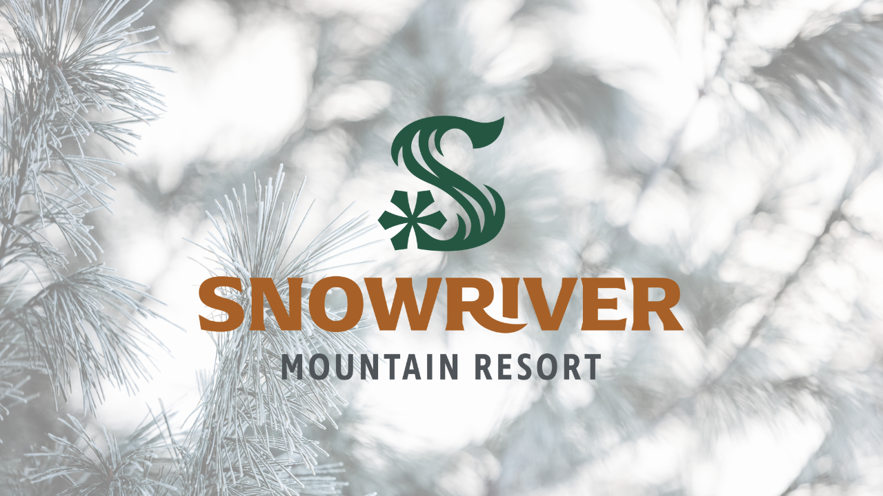 Snow-covered pine branches with Snowriver Mountain Resort logo.