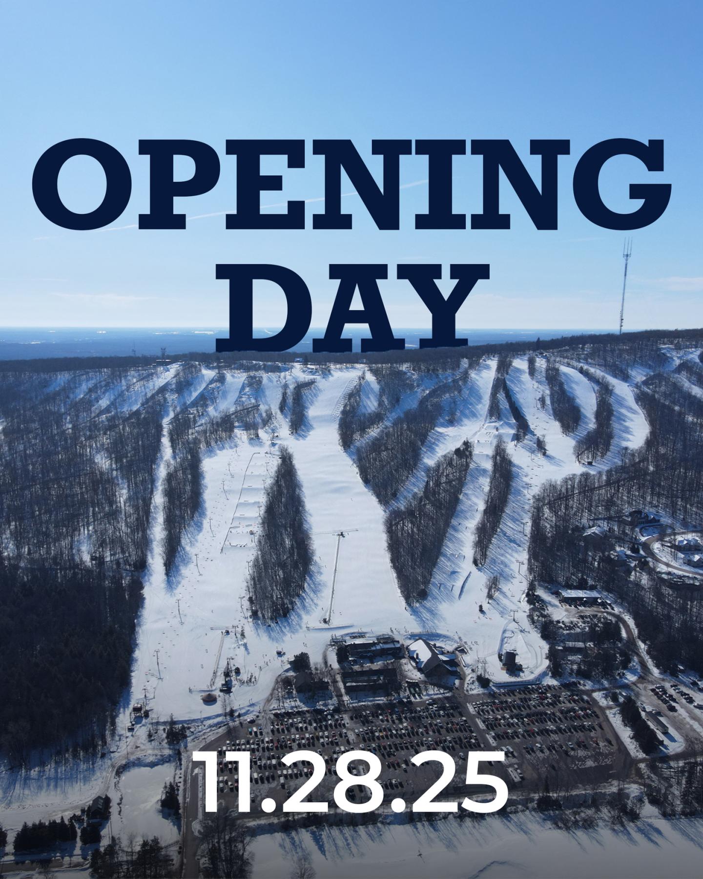 Snow-covered ski slopes under a clear blue sky.