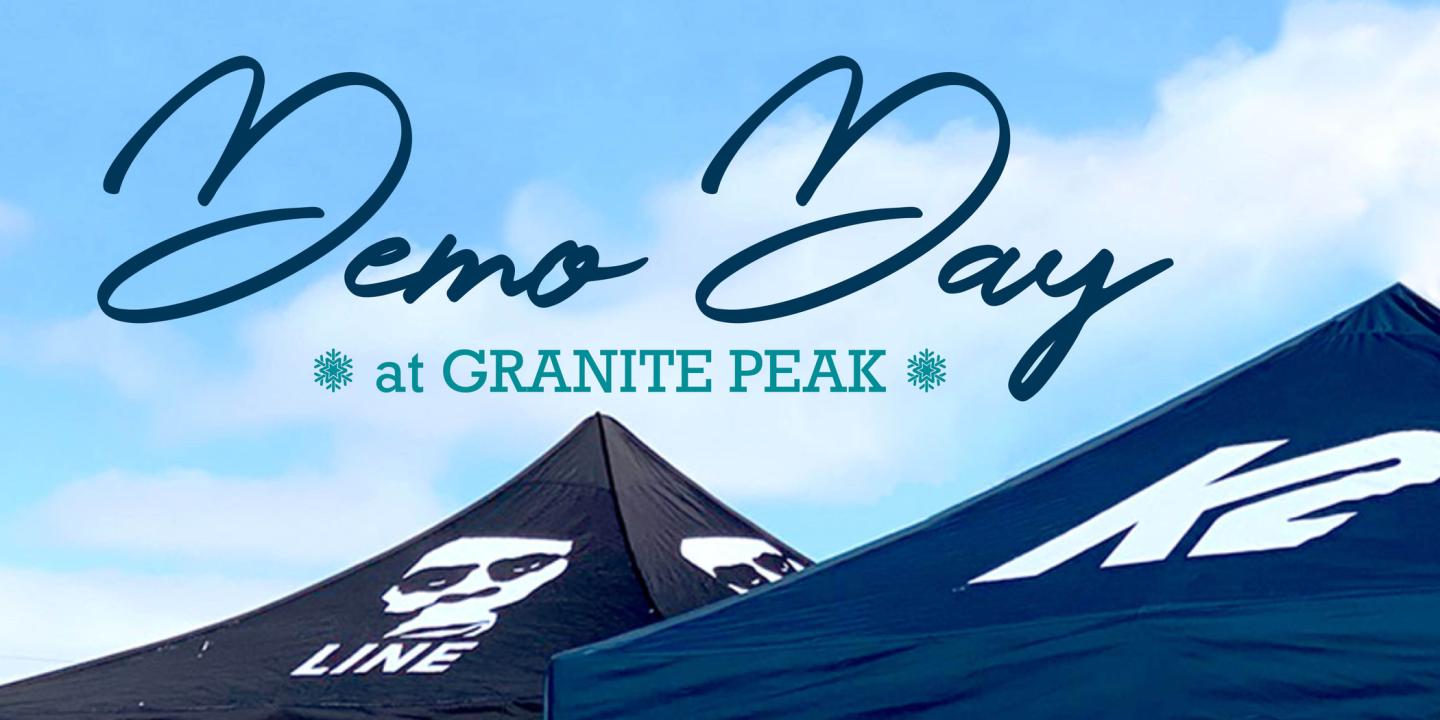 Demo Day tents with logos under a blue sky.