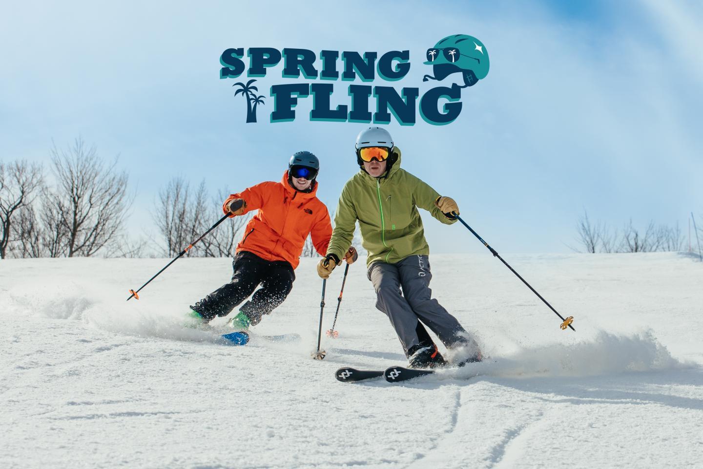 Skiers in colorful outfits racing down a snowy slope under a clear blue sky.